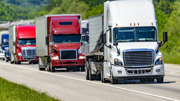 Trucks carrying freight head down the highway